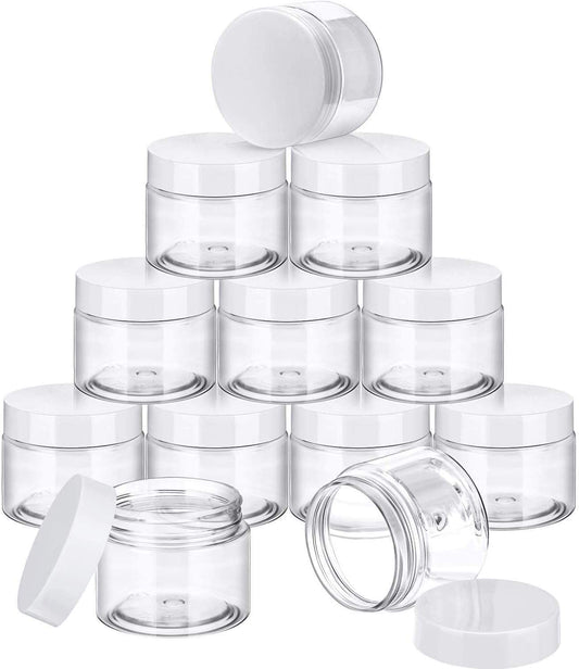 Stack of clear wide-mouth plastic cream jars with white caps, includes an open jar