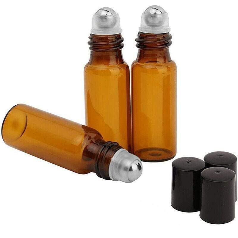 Amber glass roll-on fragrance bottles with silver ball applicators and black caps