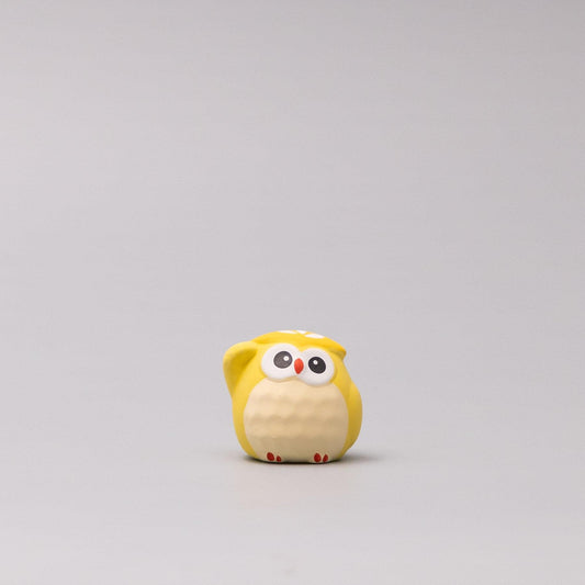 Front view yellow plush owl figurine with white face, red beak accent, and eyes