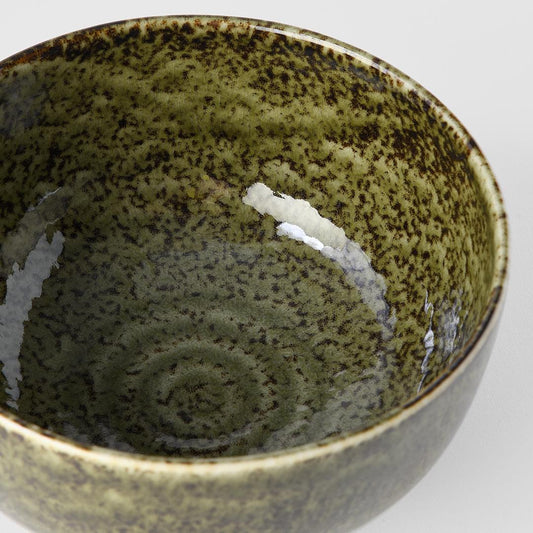 Ceramic bowl interior in sage green speckle glaze with chipped white area