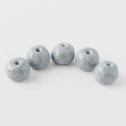 Set of grey ceramic incense stands with wave pattern and circular top openings
