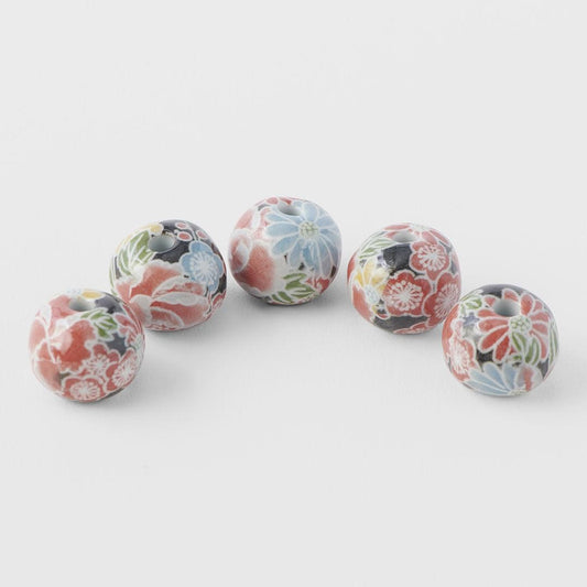 Set of five round floral incense stands with incense sticks inserted