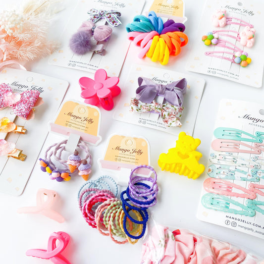 Kids surprise accessory hamper contents: colorful clips, bows, and hair ties on cards