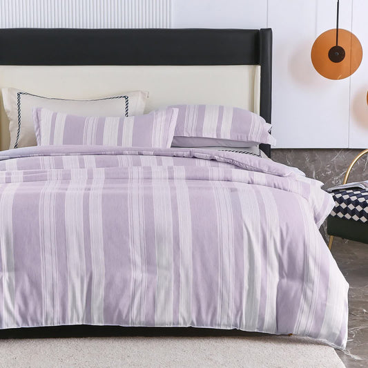 Purple and white striped comforter with two matching shams on bed