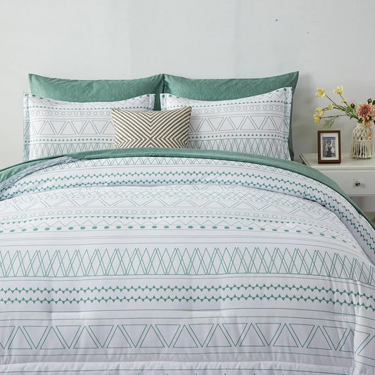 Bedding set showing comforter with green-bordered tribal motifs and matching pillow covers