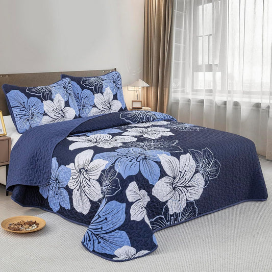 Quilted coverlet and matching pillowcases with large blue-and-white flower print
