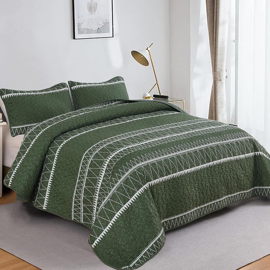 Green quilted bedspread set with two pillow shams, geometric stripe bands and zigzag trim