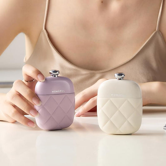 Pair of portable nail care kit cases, purple and white, with snap-top closures