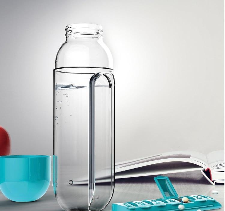 Clear water bottle with built-in pill organizer window and blue cap/holder.