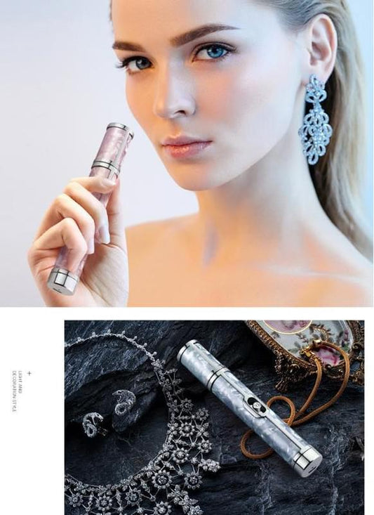 Cordless nail drill pen held at fingertip with cylindrical sanding bit
