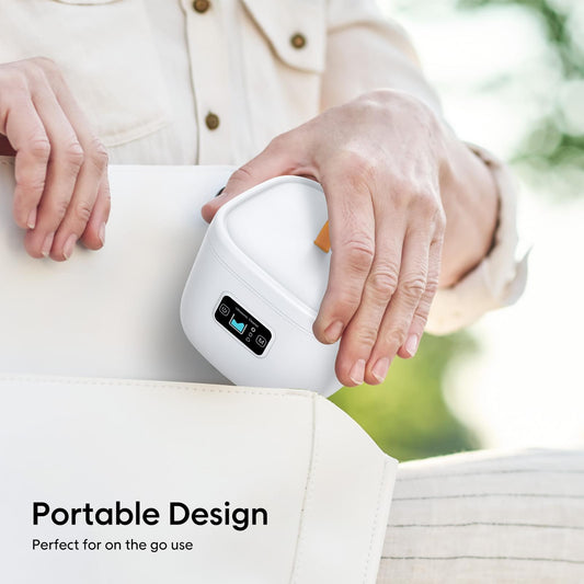Portable white ultrasonic cleaner with UV control panel, held in one hand
