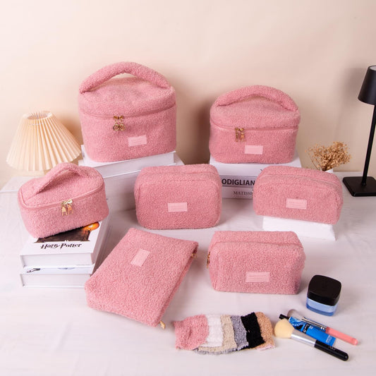 Pink plush cosmetic bag set of multiple sizes, zip closures and gold zipper pulls
