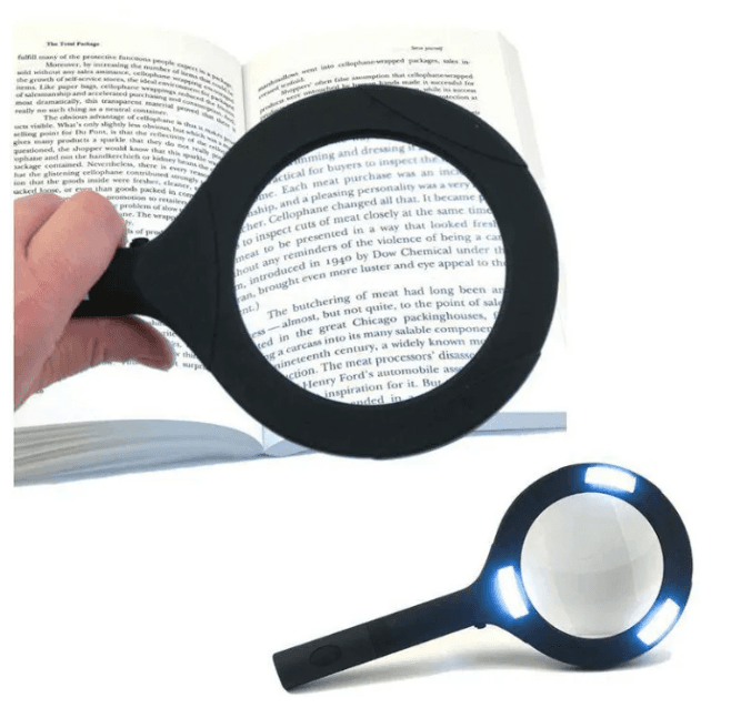 LED magnifying glass over an open book, illuminated round lens with black frame