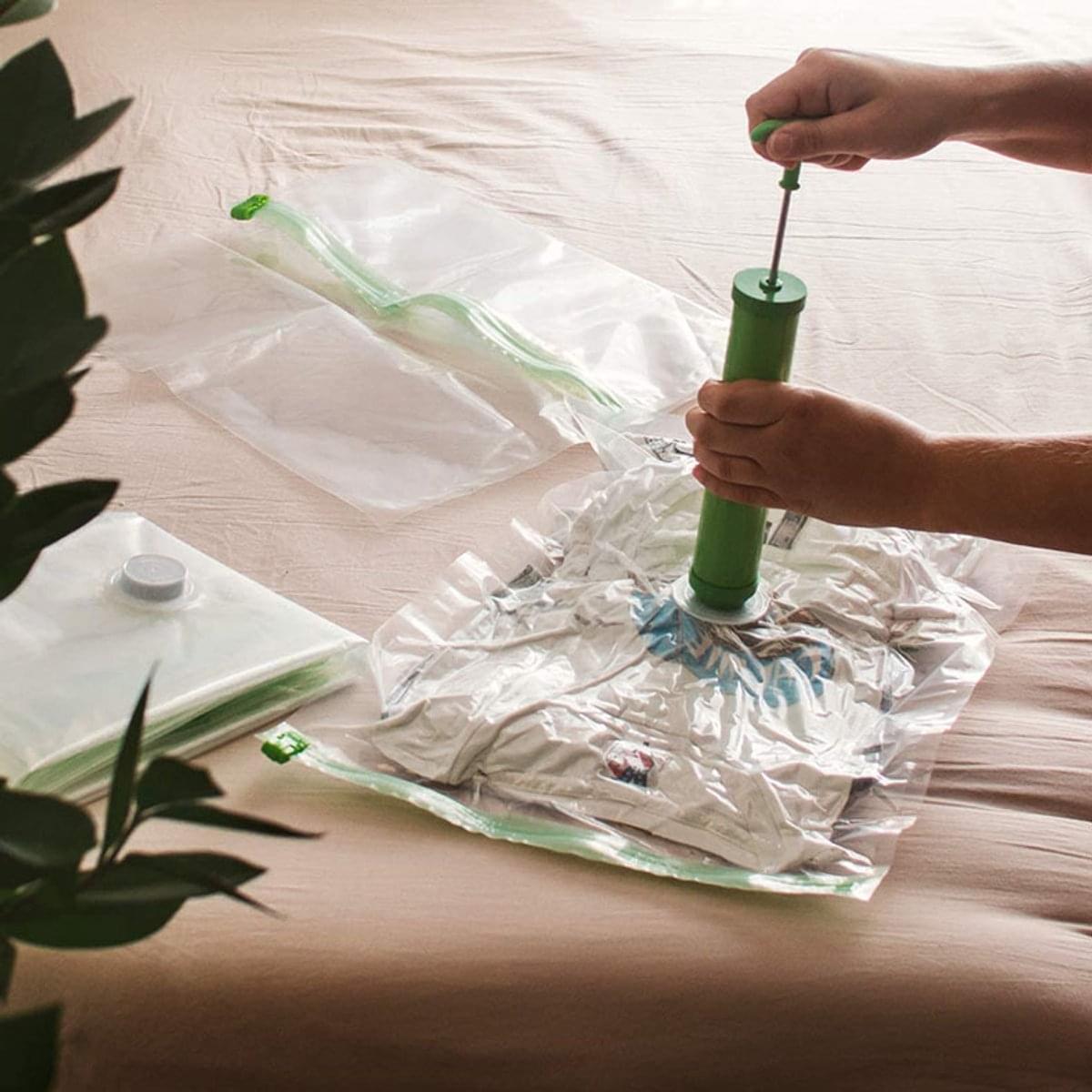 Vacuum storage bag being inflated with green hand pump, valve attached