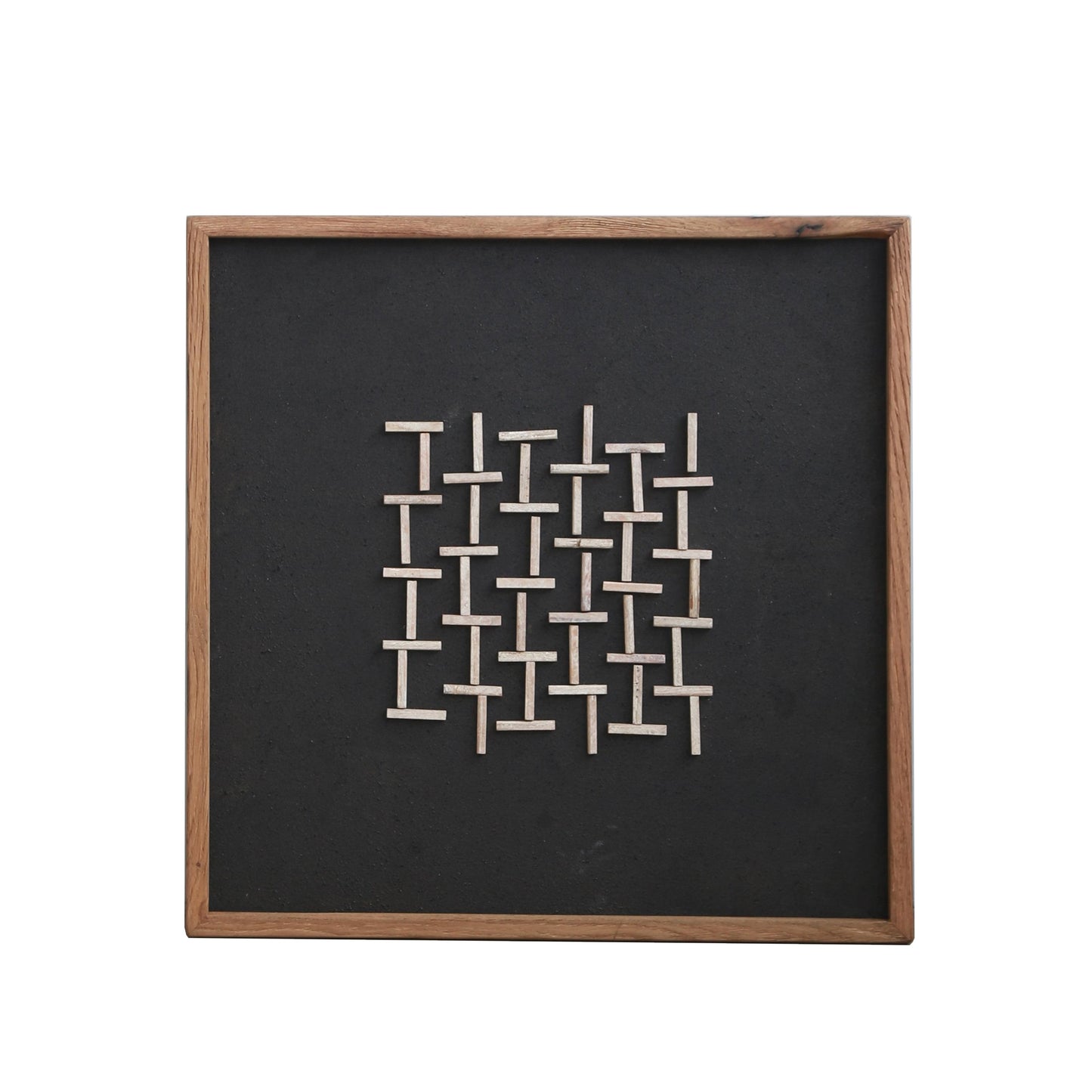 Framed wall art with dark square backing and white interlocking bar design, wood frame