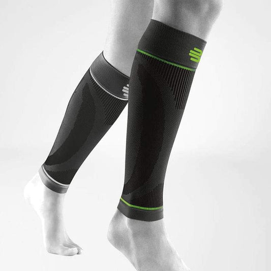 Black sports compression calf sleeves with neon green trim and textured support panels
