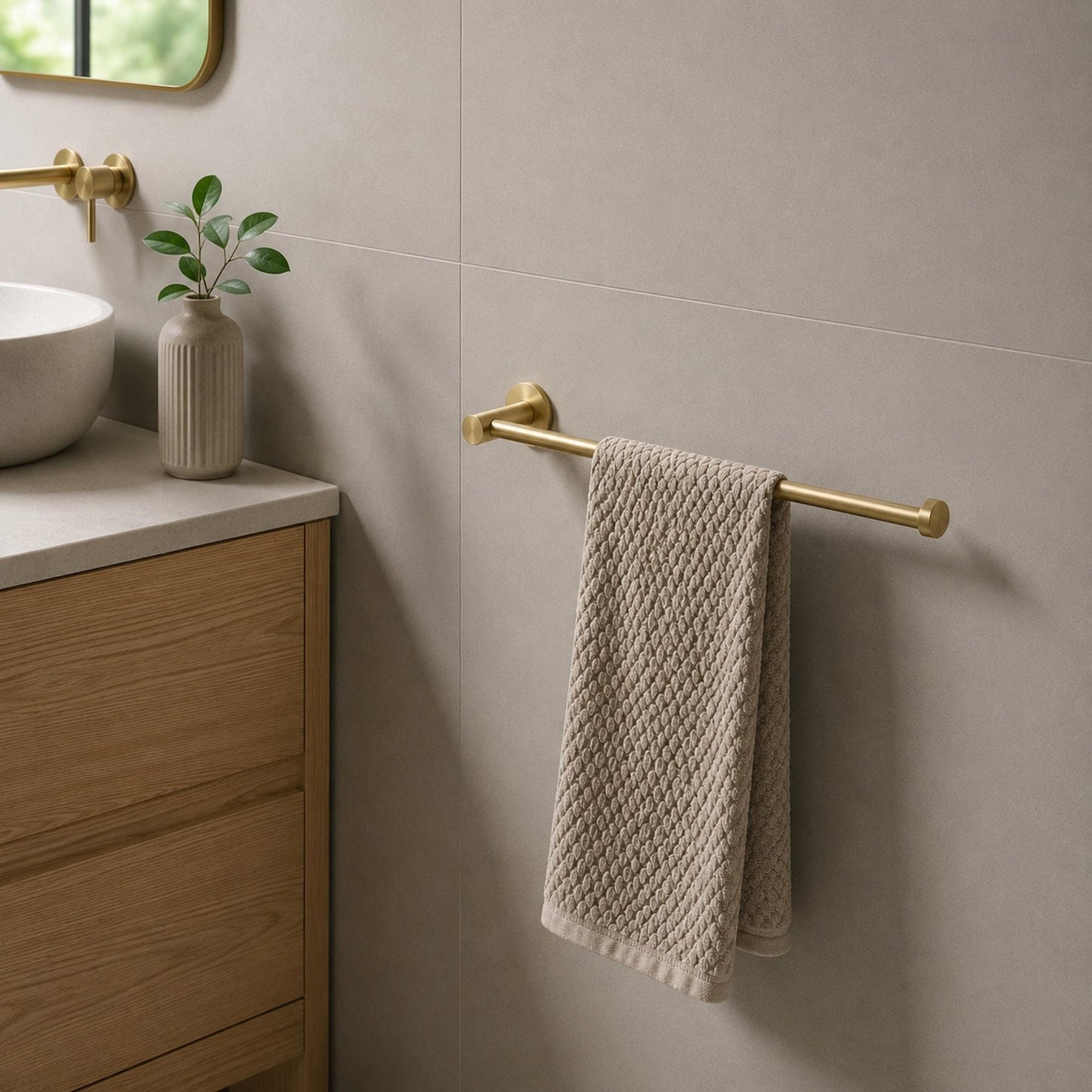 Brushed brass wall-mounted hand towel holder, holds one folded towel