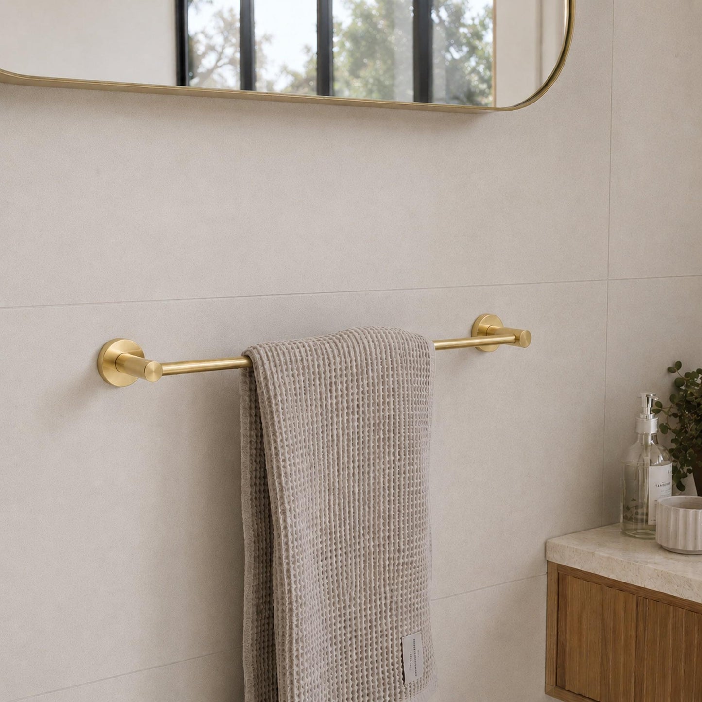 Brushed brass single towel rail with hanging light gray towel