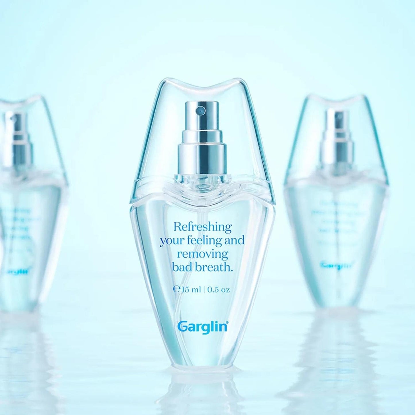 Garglin fresh breath mint spray bottle with silver pump on clear surface