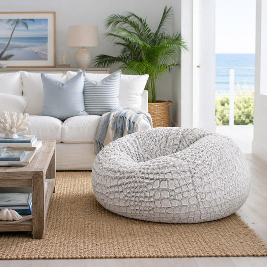 Light gray/white faux-fur bean bag, round oval with textured shell surface