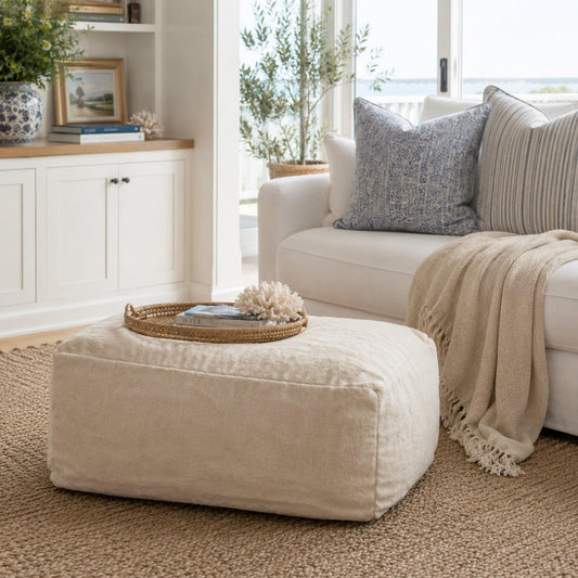 Light champagne plush ottoman with low profile and soft, rounded corners.