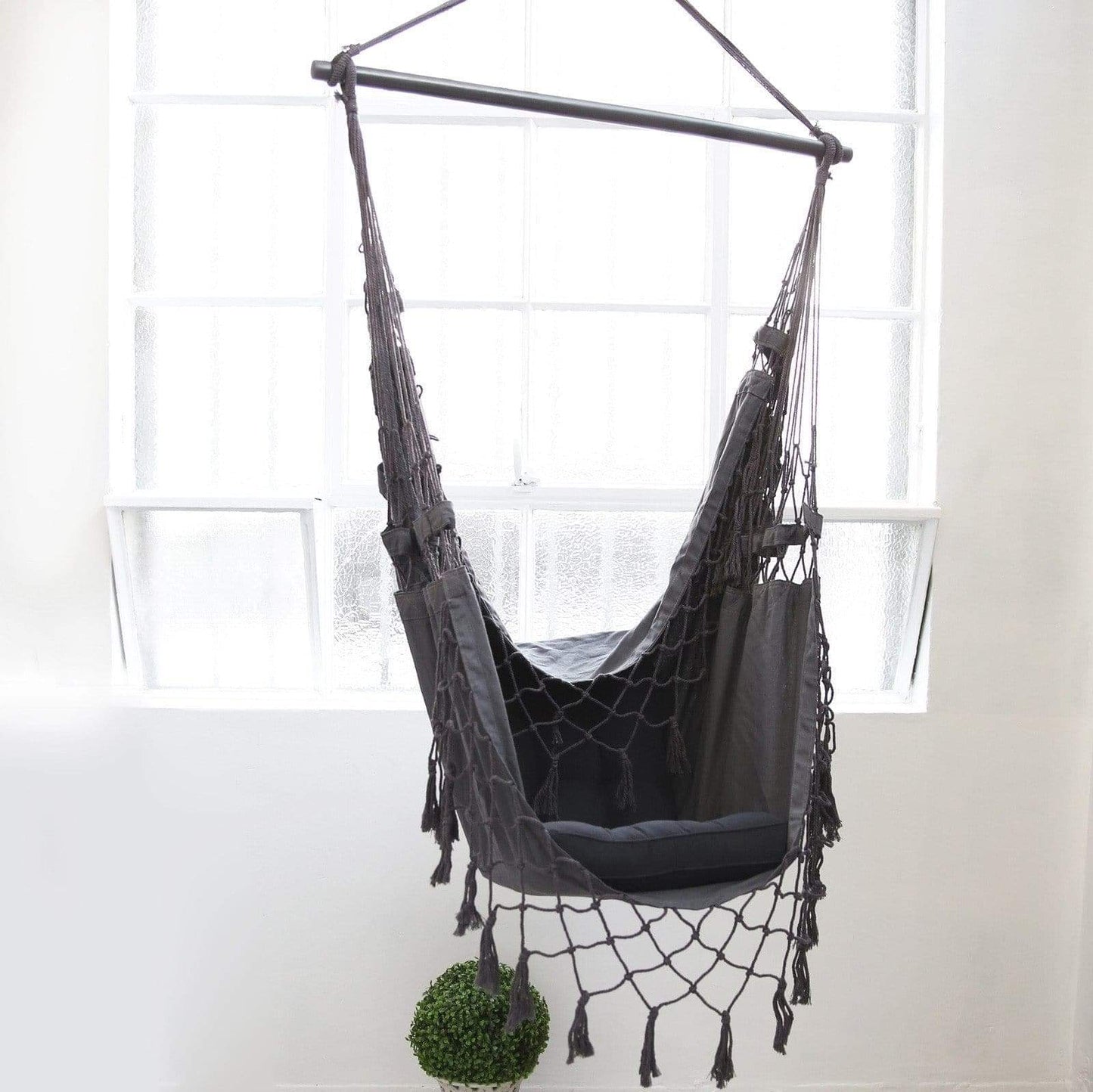 Charcoal hanging hammock chair with padded seat, open net back, fringe ropes
