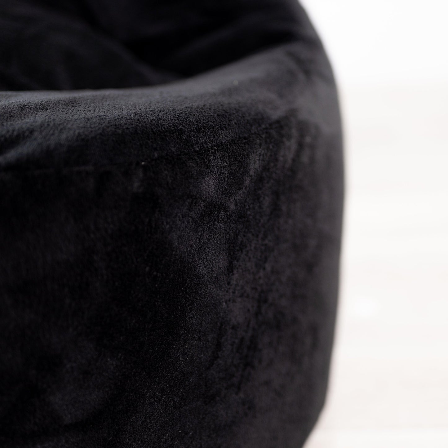 Black plush fur bean bag chair cover side panel with tufted texture