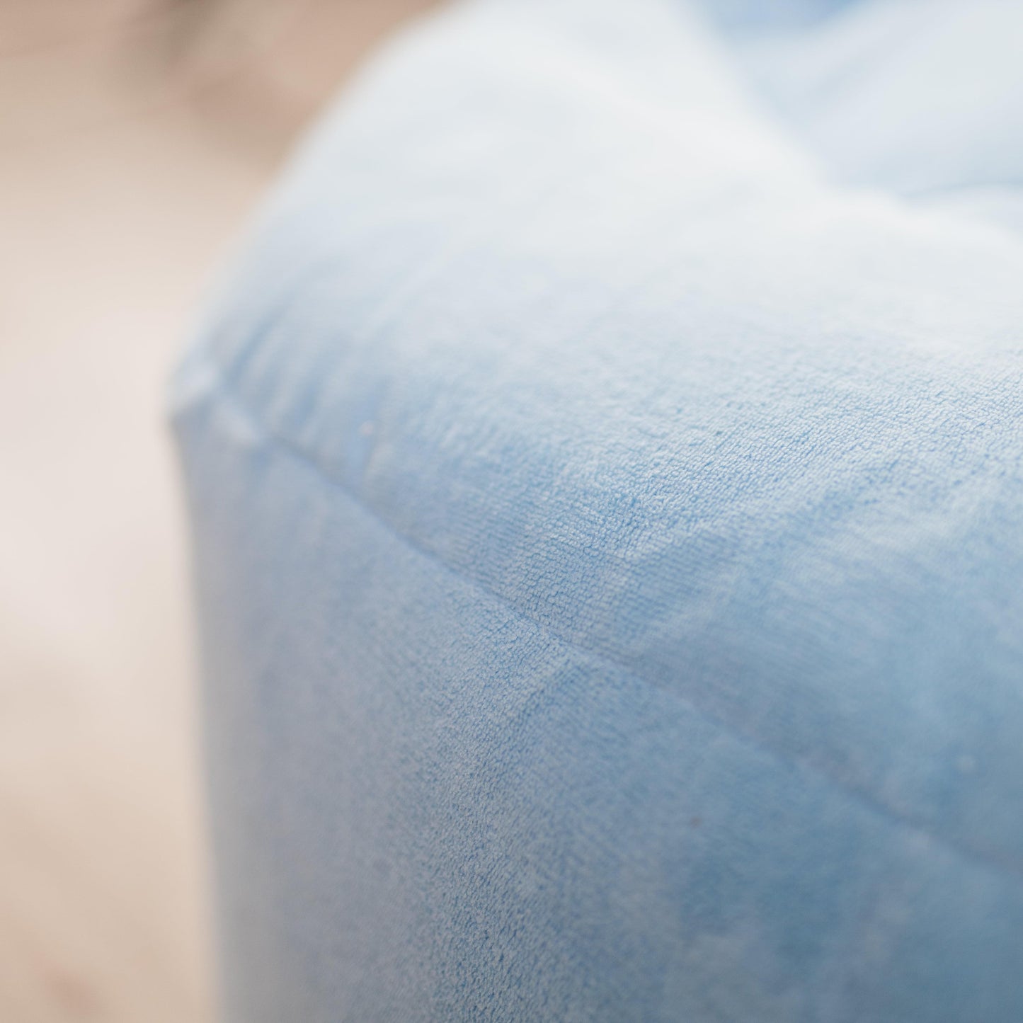 Close-up of light blue plush bean bag cover fabric texture
