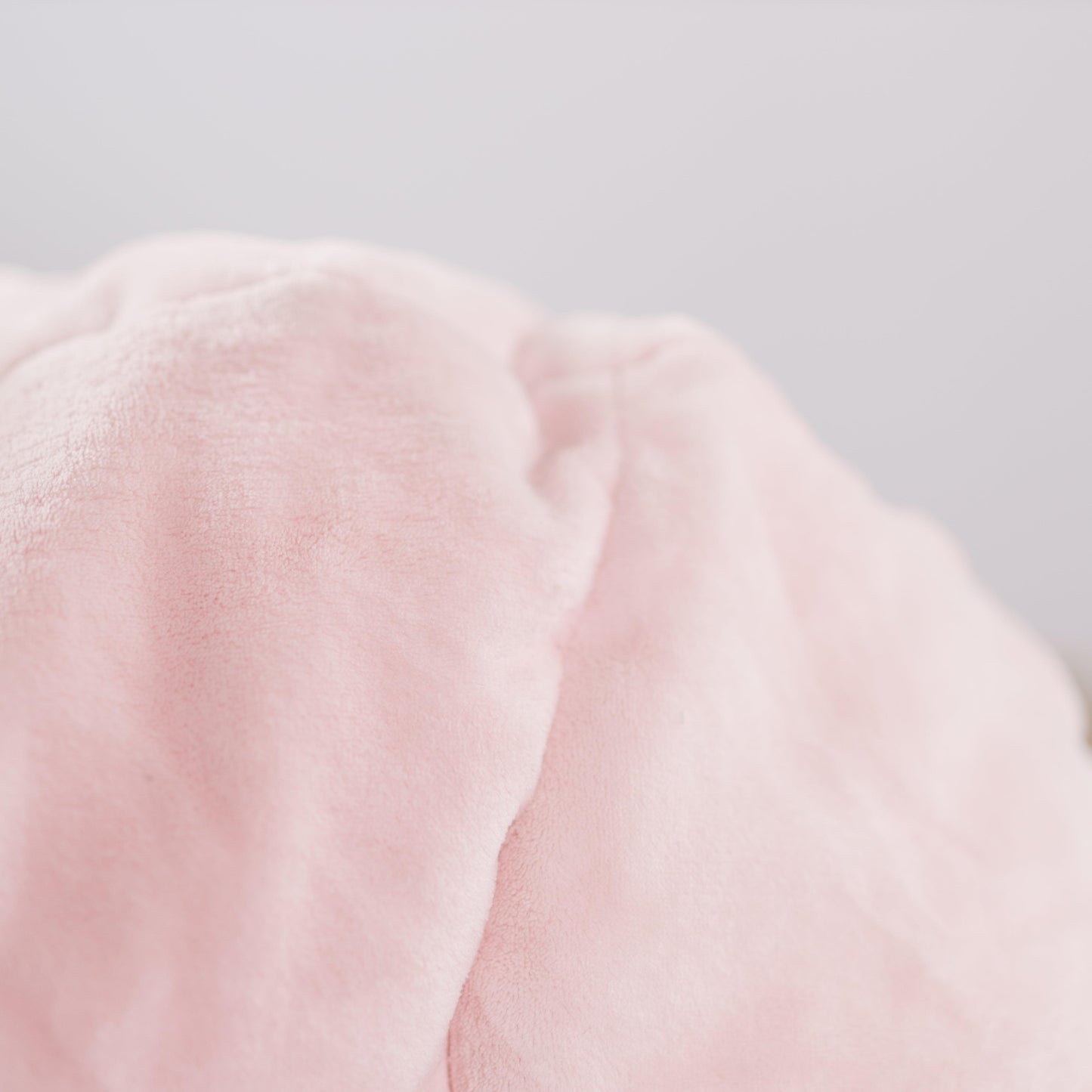 Close-up of soft pink plush fur texture on bean bag chair cover