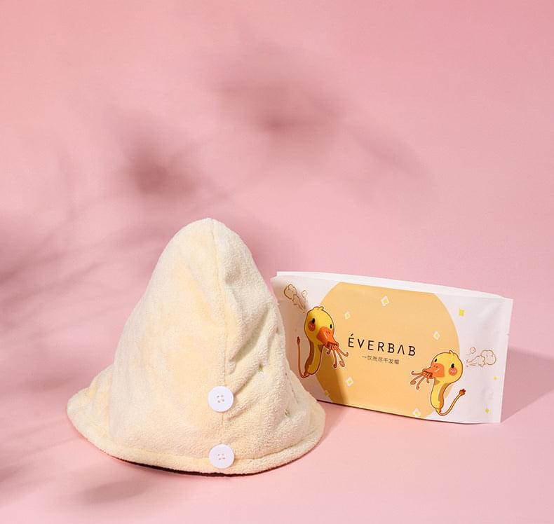 Light beige hooded hair towel wrap with octopus print and snap buttons