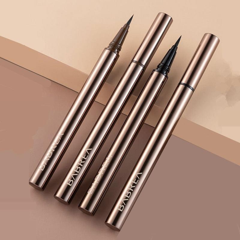 Assorted waterproof eyeliner pencils with brush tips, metallic gold bodies