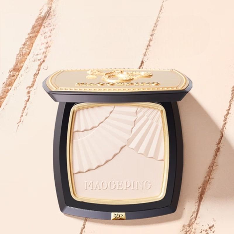 Pressed powder compact with gold lid and light beige pressed powder pan