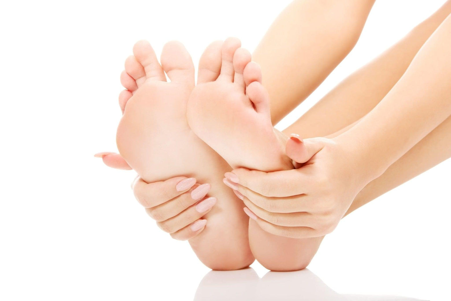 Foot care: hands massaging moisturiser onto dry heels, visible feet