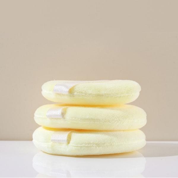 Cream makeup powder puffs, three stacked round sponges