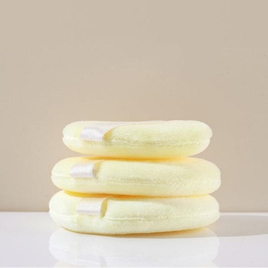 Cream makeup powder puffs, three stacked round sponges