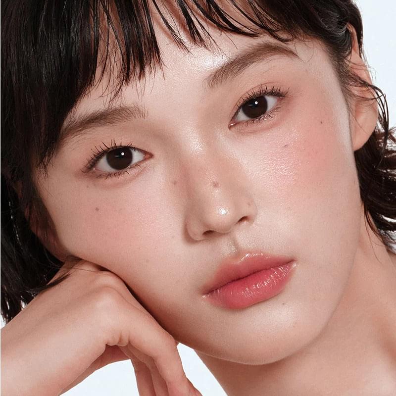 Lip & cheek balm pencil on lips with soft rosy finish, close-up