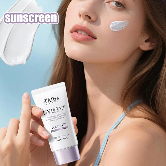 Tone-up sun cream tube in hand with face application, white-lavender formula, SPF50+ PA++++