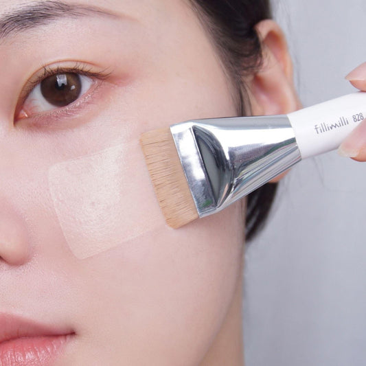 Fillimilli 828 mini spatula brush applying skincare to cheek with flat bristles