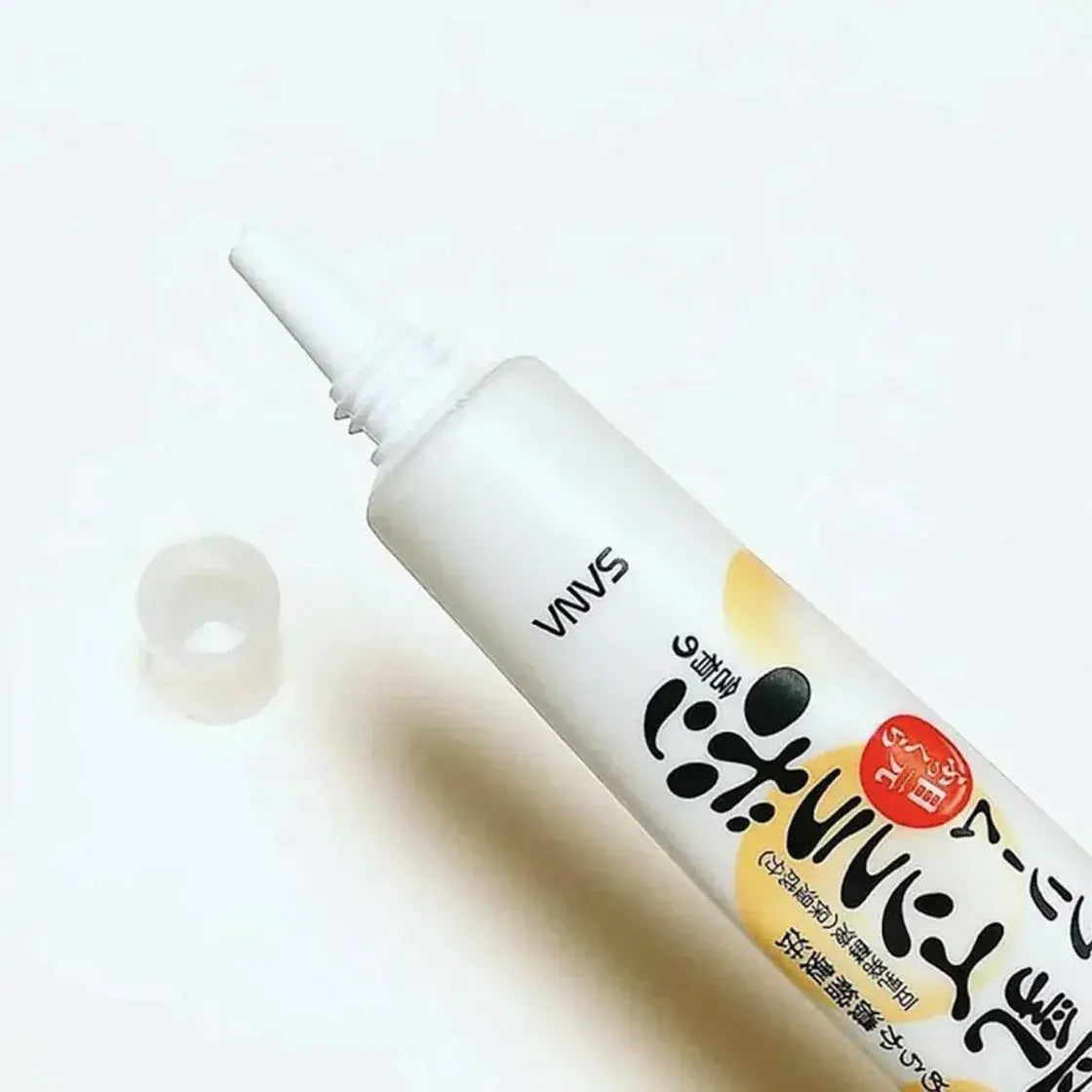 Eye cream pump nozzle dispensing from white bottle, paws motif and red badge