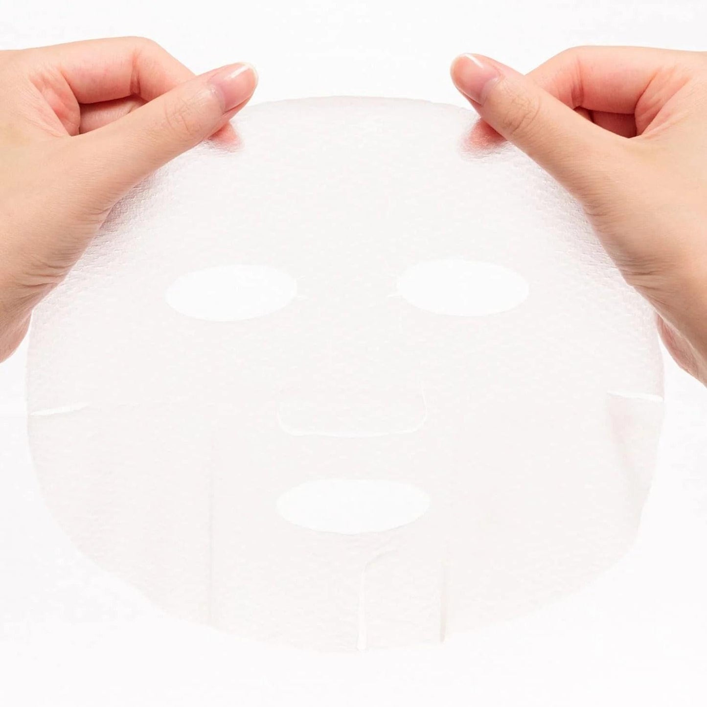 Face mask sheet held by hands, white sheet with eye and nose cutouts