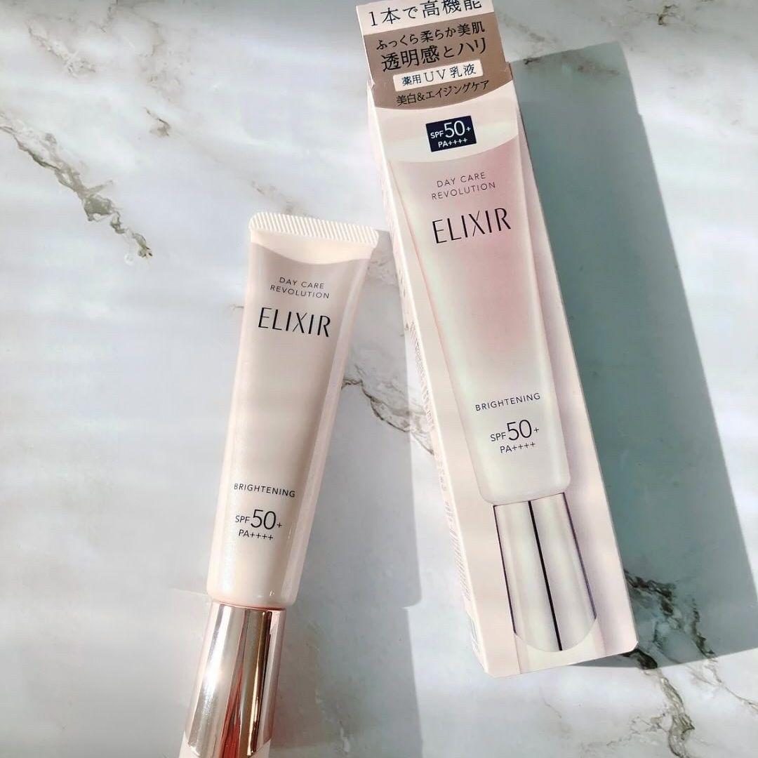 Two UV brightening emulsion tubes SPF50+ with metallic bases, cream-pink.
