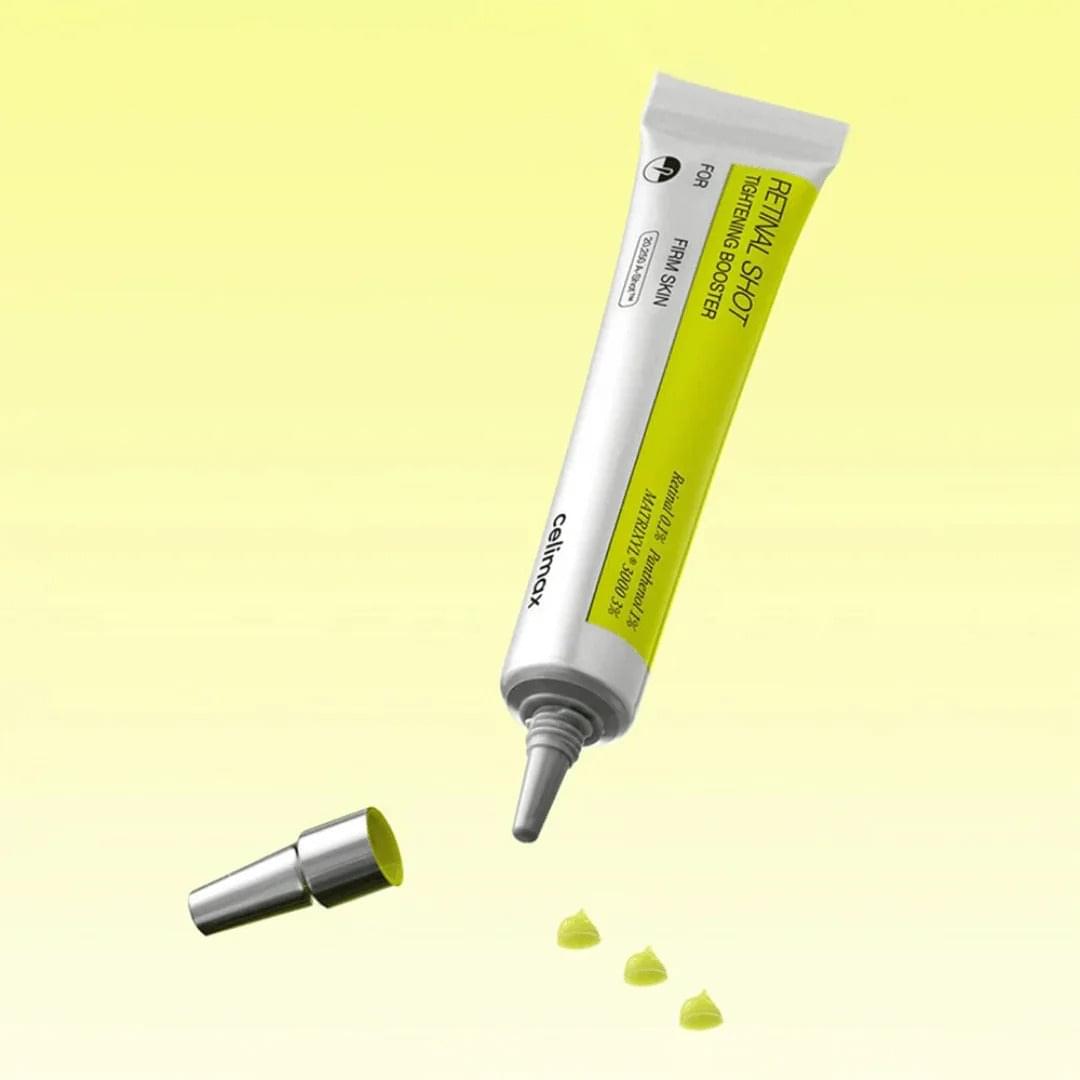 Squeeze tube dispensing yellow gel droplets with silver applicator tip