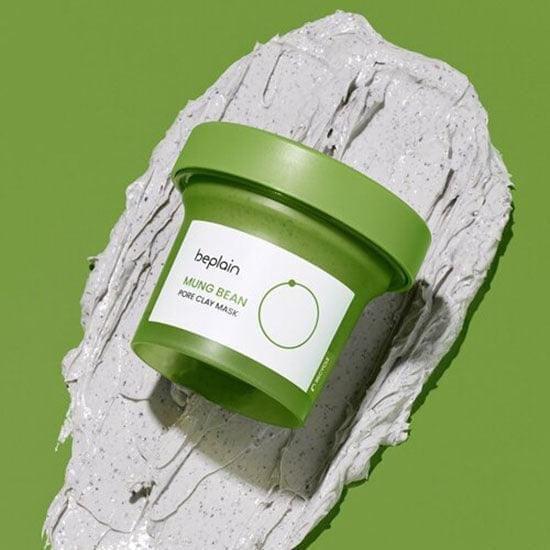Mung bean pore clay mask jar surrounded by thick white clay paste