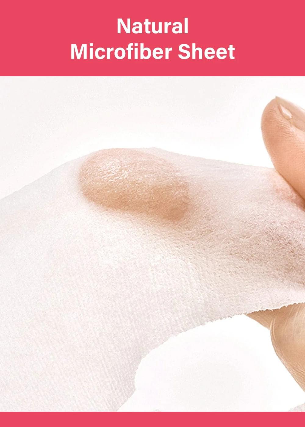 Microfiber sheet mask fabric held in hand with light cream on the surface