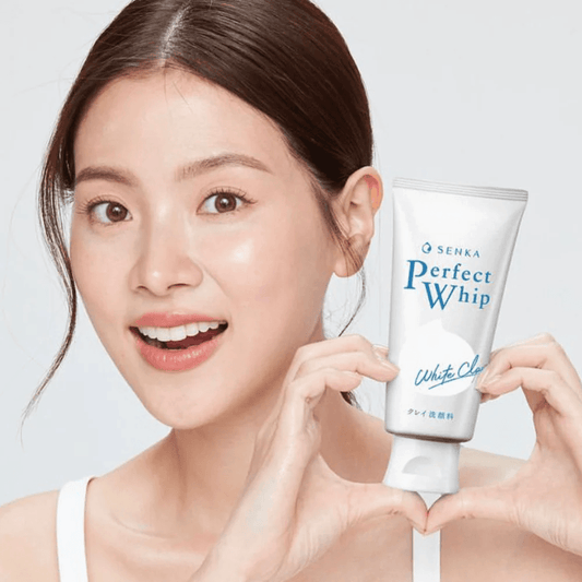 White clay facial cleanser tube held in hand, Senka Perfect Whip branding.