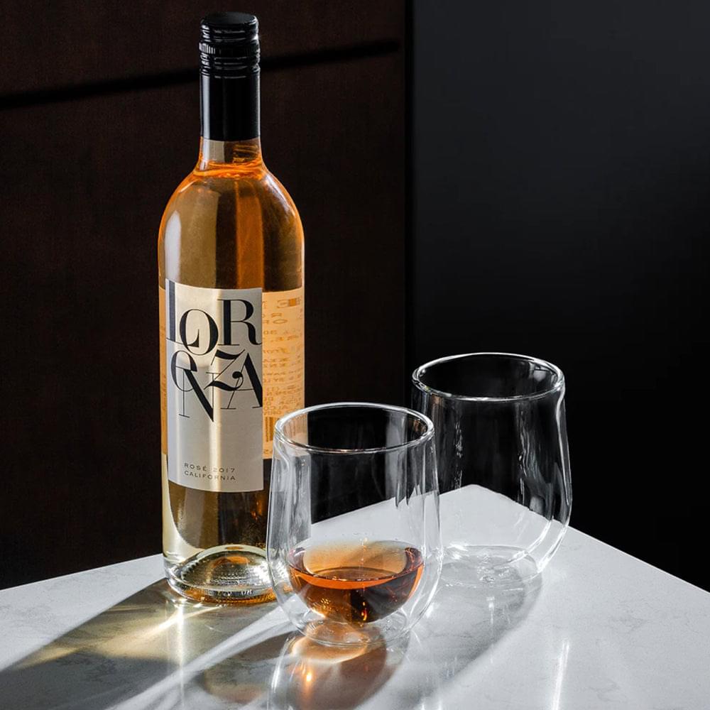 Set of clear stemless glass tumblers on a tabletop