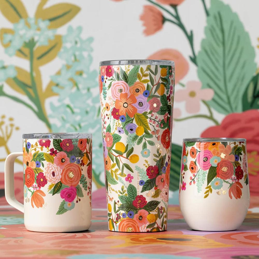 Floral printed cream tumbler with lid, multiple angles on table