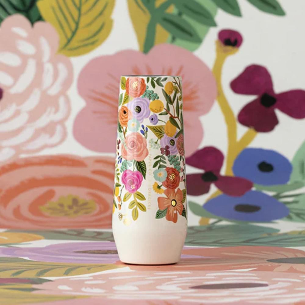 Stemless flute tumbler with colorful floral print on a cream base