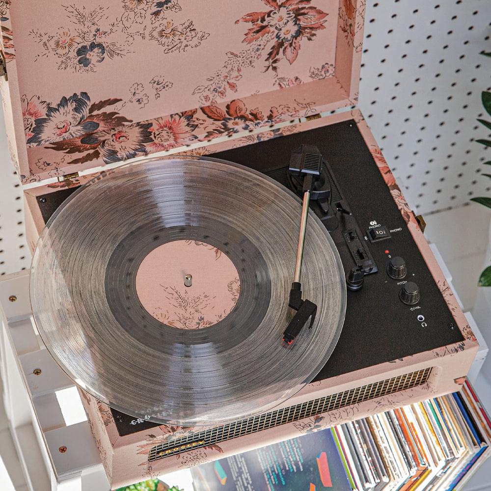 Floral portable turntable with vinyl record on platter and control knobs visible