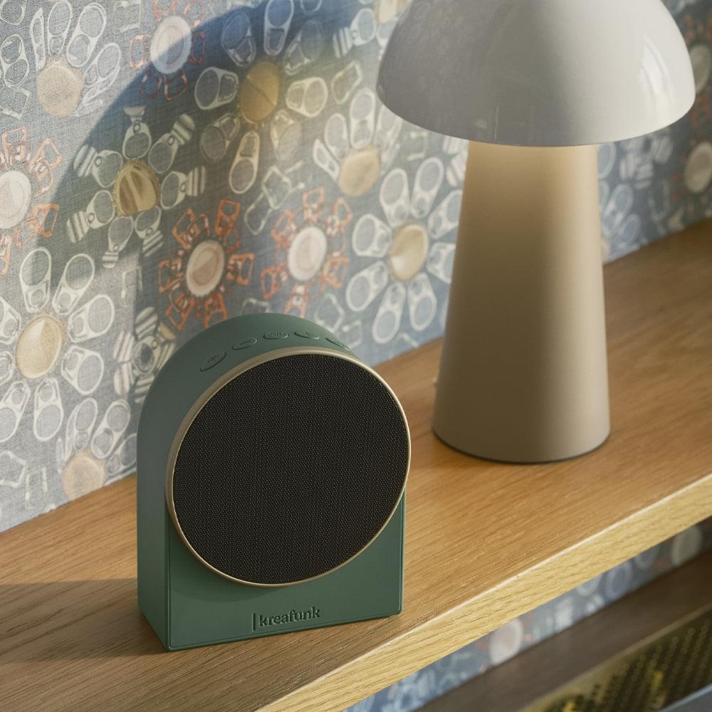 Nordic green alarm clock speaker, side view with round grille and digital display